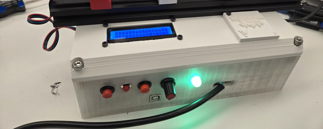 The printed controller enclosure, showing three red push buttons, a black rotary knob, a USB socket and a green indicator lit beside them.